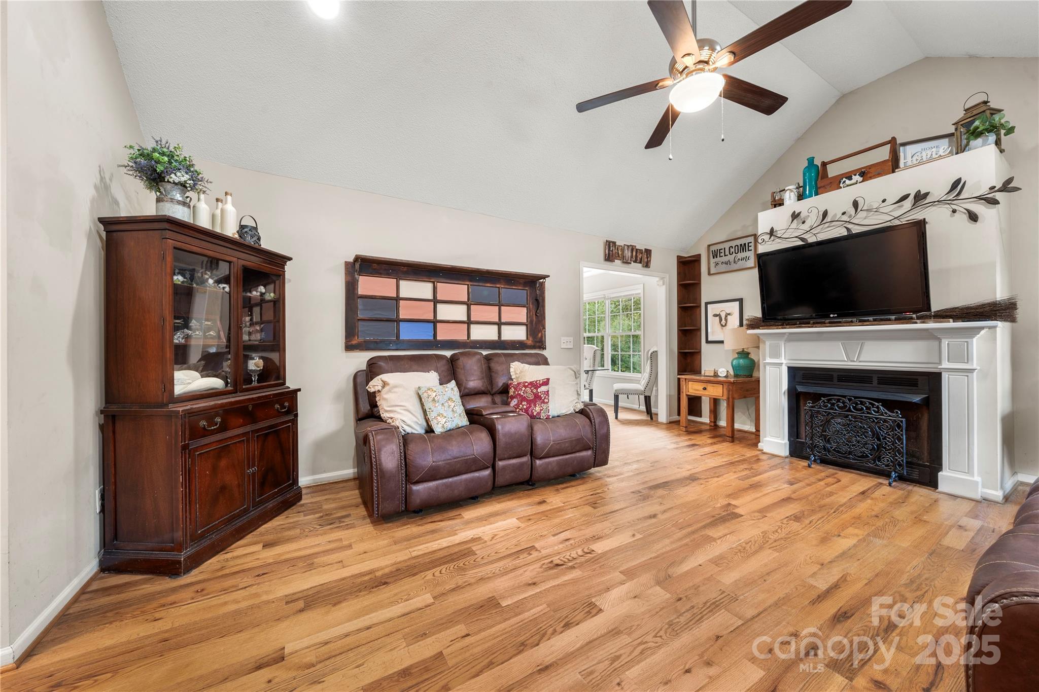 2430 Dr Nichols Road York, SC 29745 - Photo 12 of 26 a living room with furniture a fireplace and a flat screen tv