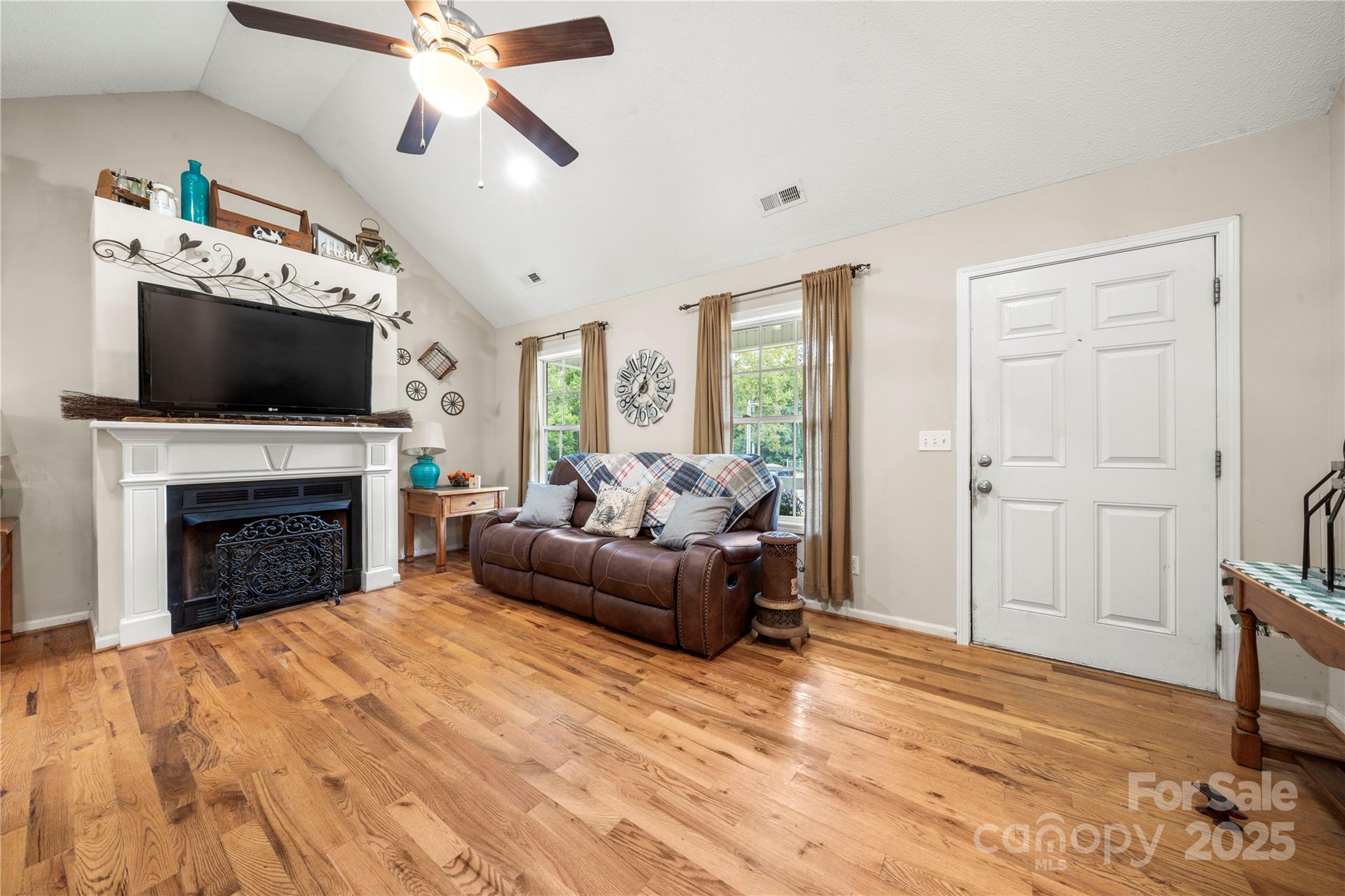2430 Dr Nichols Road York, SC 29745 - Photo 13 of 26 a living room with furniture a fireplace and a flat screen tv