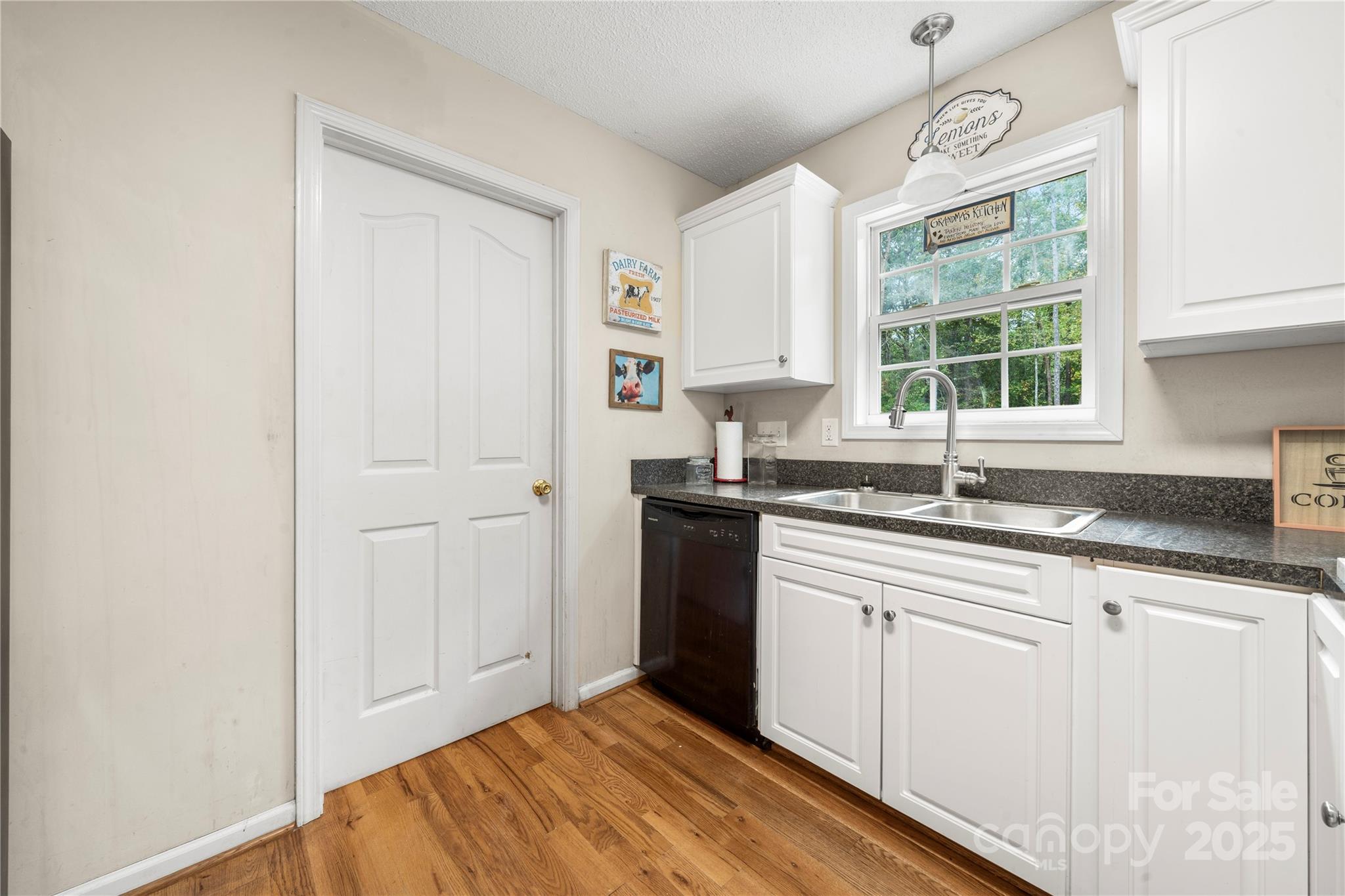 2430 Dr Nichols Road York, SC 29745 - Photo 15 of 26 a kitchen with granite countertop white cabinets and a window