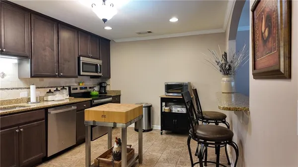 a kitchen with a sink cabinets and appliances