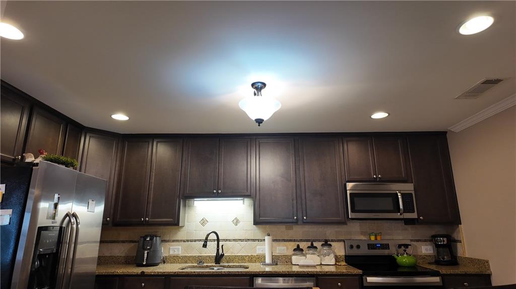 115 Old Mill Drive Calhoun, GA 30701 - Photo 12 of 39 a kitchen with a sink stainless steel appliances and cabinets