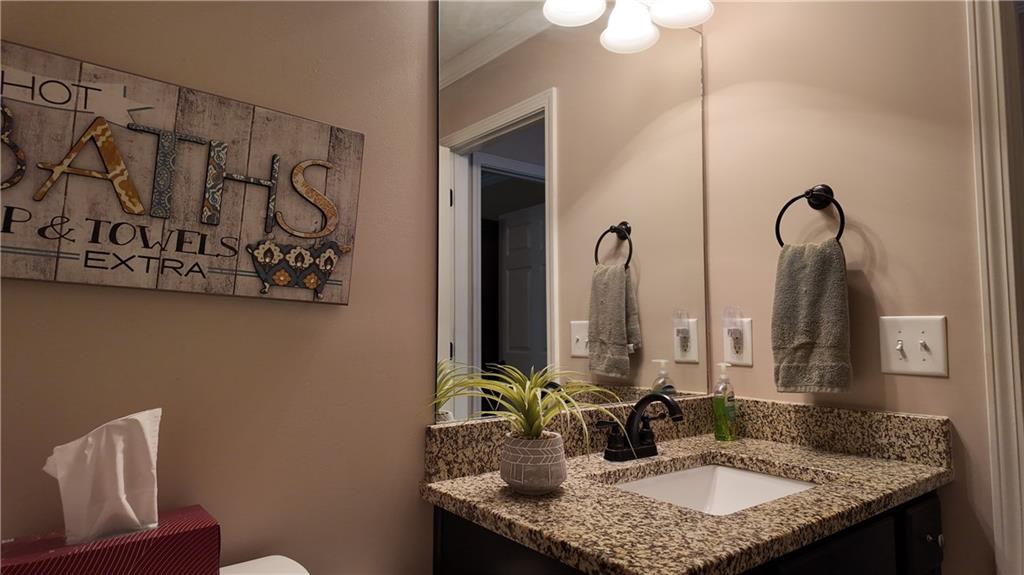 115 Old Mill Drive Calhoun, GA 30701 - Photo 20 of 39 a bathroom with a granite countertop sink and a mirror