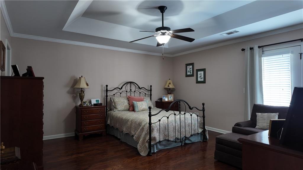 115 Old Mill Drive Calhoun, GA 30701 - Photo 23 of 39 a bedroom with a bed and wooden floor