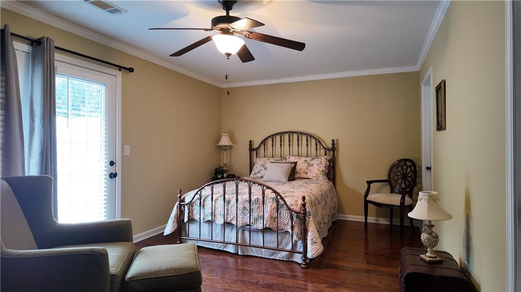 115 Old Mill Drive Calhoun, GA 30701 - Photo 29 of 39 a bedroom with a bed and a chandelier