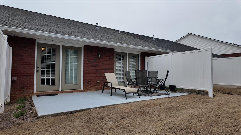 115 Old Mill Drive Calhoun, GA 30701 - Photo 33 of 39 a view of a patio with table and chairs and wooden floor