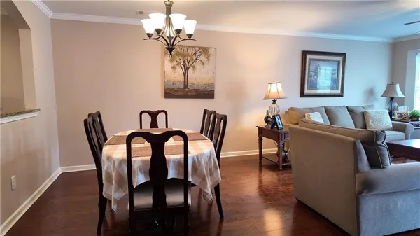 a view of a dining room with furniture wooden floor and chandelier