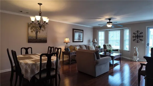 a living room with furniture chandelier and a window