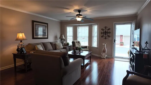 a living room with furniture and wooden floor