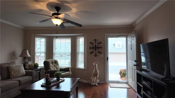 a view of a livingroom with workspace and a window