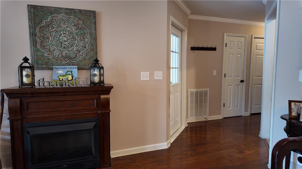 115 Old Mill Drive Calhoun, GA 30701 - Photo 8 of 39 a view of a hallway with wooden floor and a fireplace