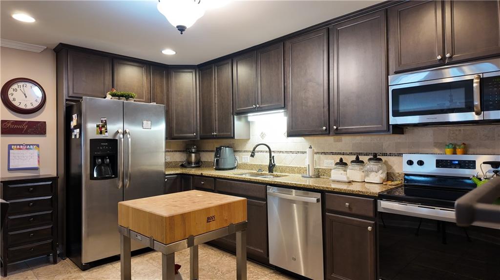 115 Old Mill Drive Calhoun, GA 30701 - Photo 10 of 39 a kitchen with stainless steel appliances granite countertop a sink stove and refrigerator