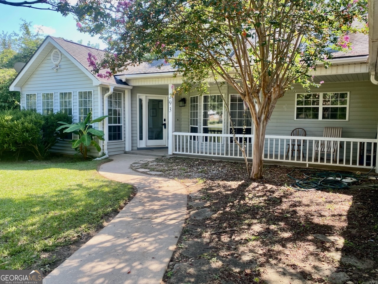a front view of a house with garden