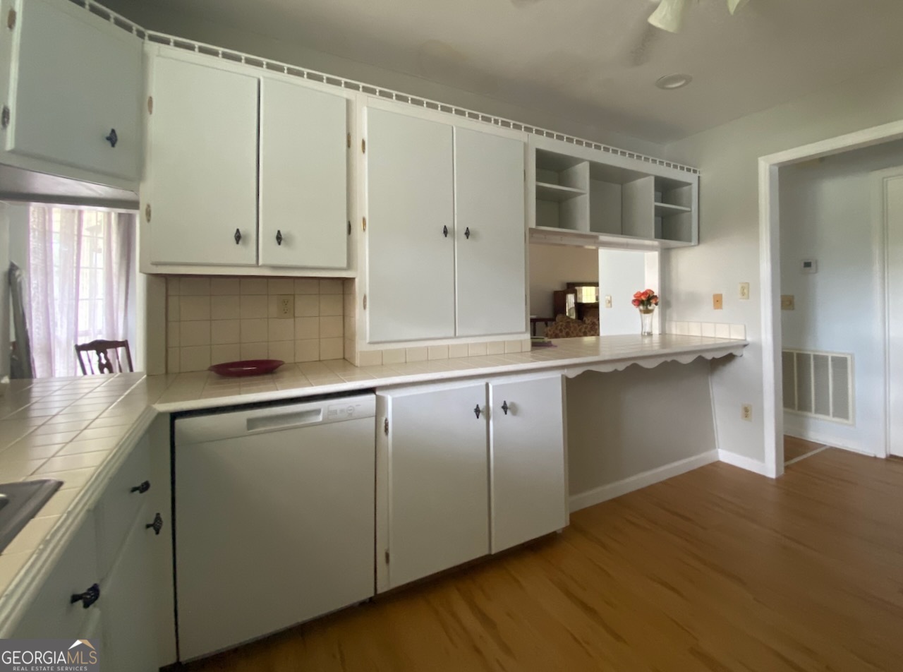 293 Osage Circle Byron, GA 31008 - Photo 11 of 31 a kitchen with granite countertop white cabinets and white appliances
