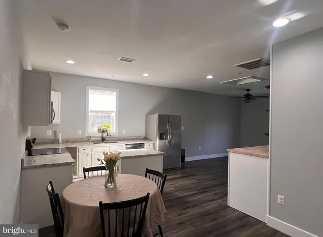 a kitchen with a table and chairs in it