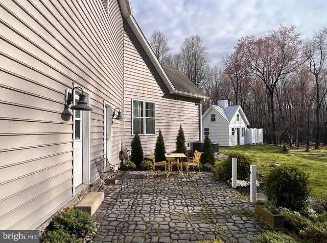 a view of a chairs and table in backyard of the house