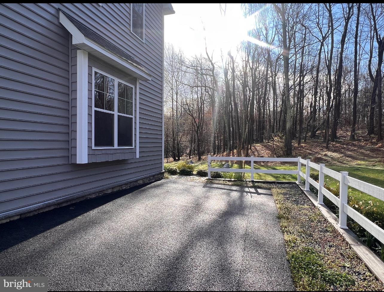 8449 Stevens Road Owings, MD 20736 - Photo 6 of 6 a view of a backyard with a table and chairs and wooden fence