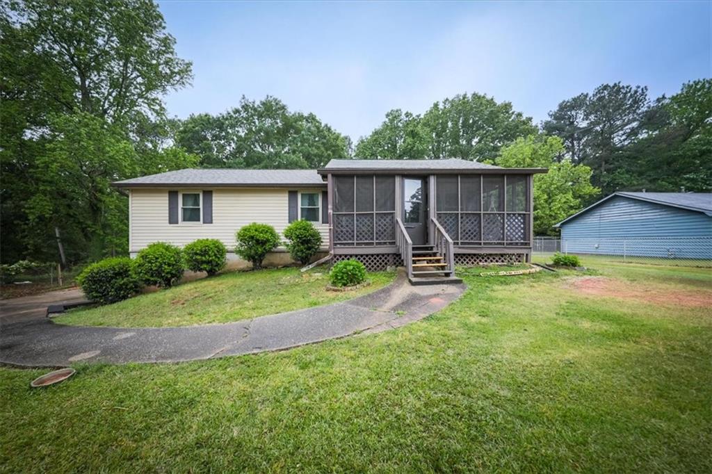 1215 Anderson Mill Road Austell, GA 30106 - Photo 1 of 1 a view of a backyard with a slide trees and wooden fence