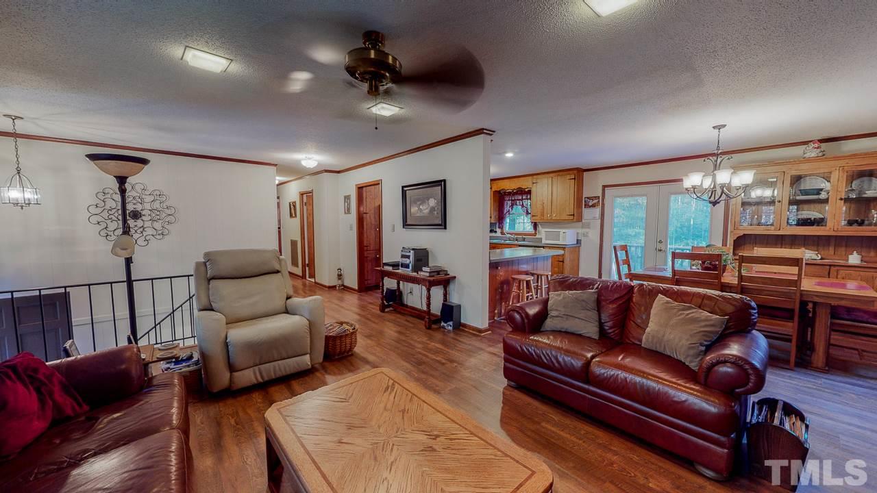 1307 Bill Poole Road Rougemont, NC 27572 - Photo 2 of 30 a living room with furniture ceiling fan and a rug