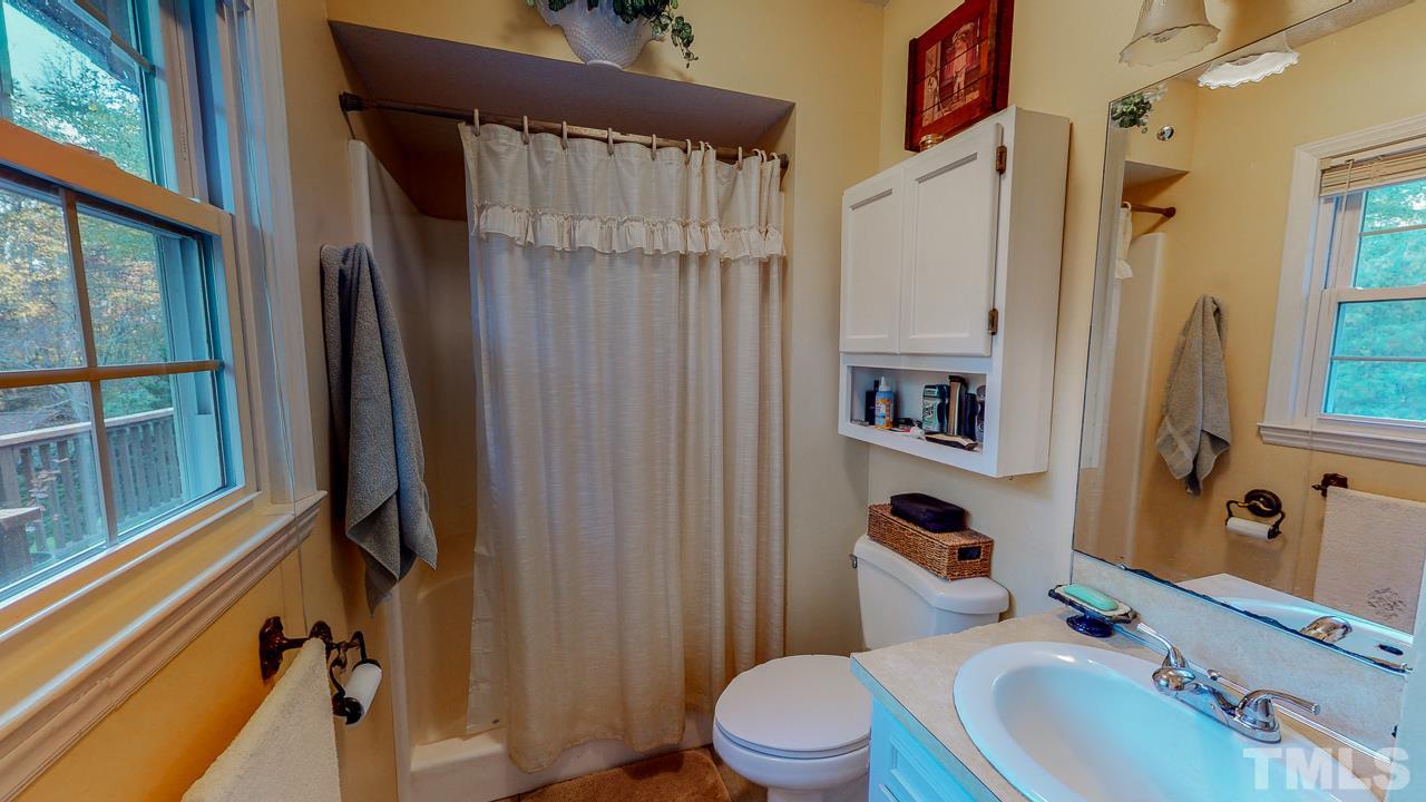1307 Bill Poole Road Rougemont, NC 27572 - Photo 17 of 30 a bathroom with a sink toilet and shower