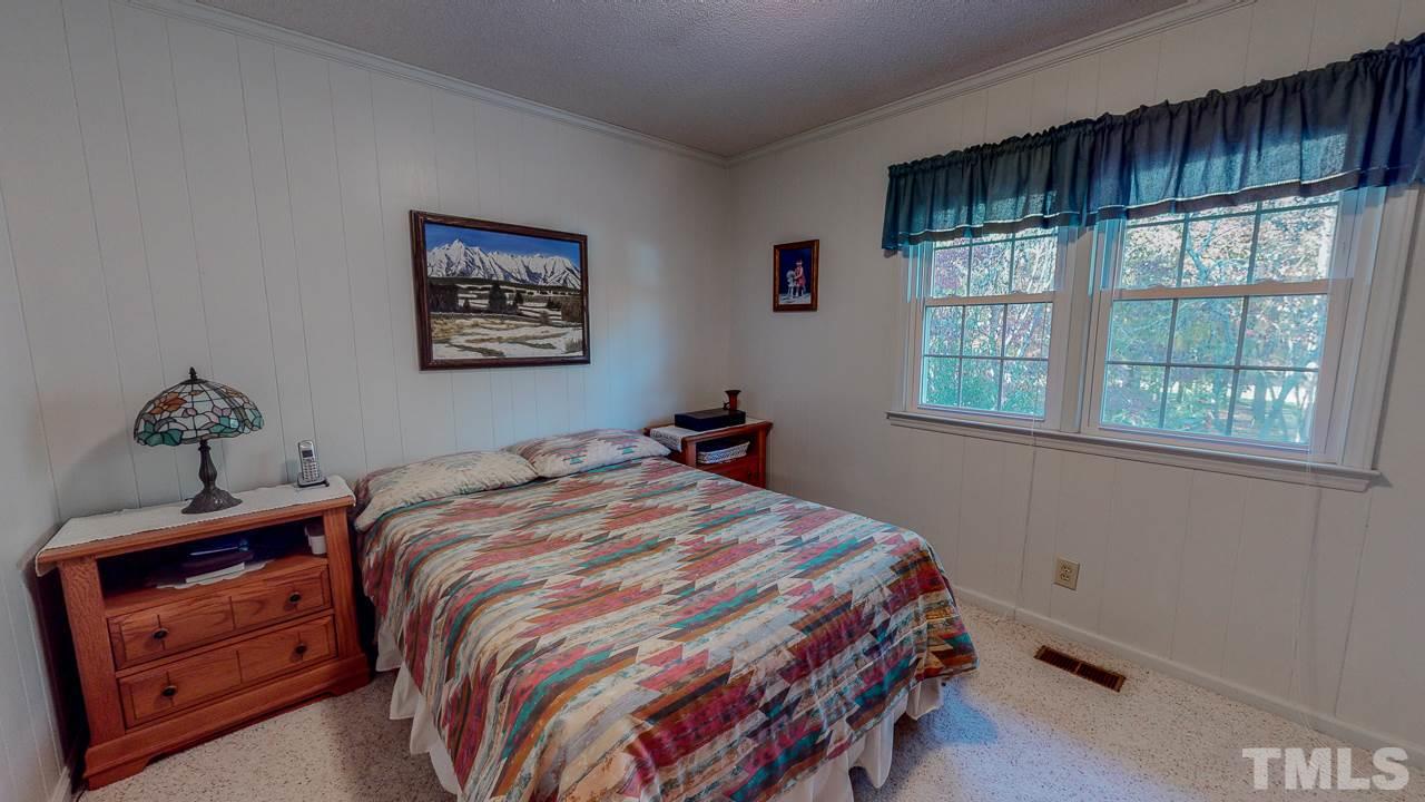 1307 Bill Poole Road Rougemont, NC 27572 - Photo 18 of 30 a bedroom with a bed and a window