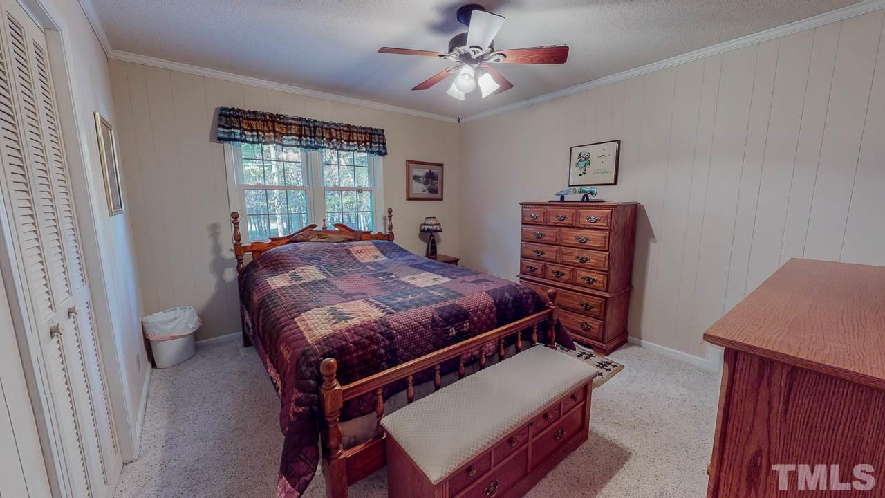 1307 Bill Poole Road Rougemont, NC 27572 - Photo 19 of 30 a bed sitting in a bedroom next to a window