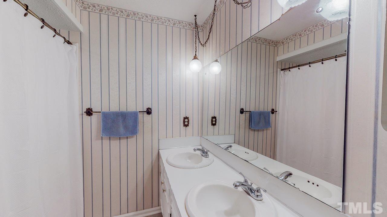 1307 Bill Poole Road Rougemont, NC 27572 - Photo 20 of 30 a bathroom with a sink and mirror