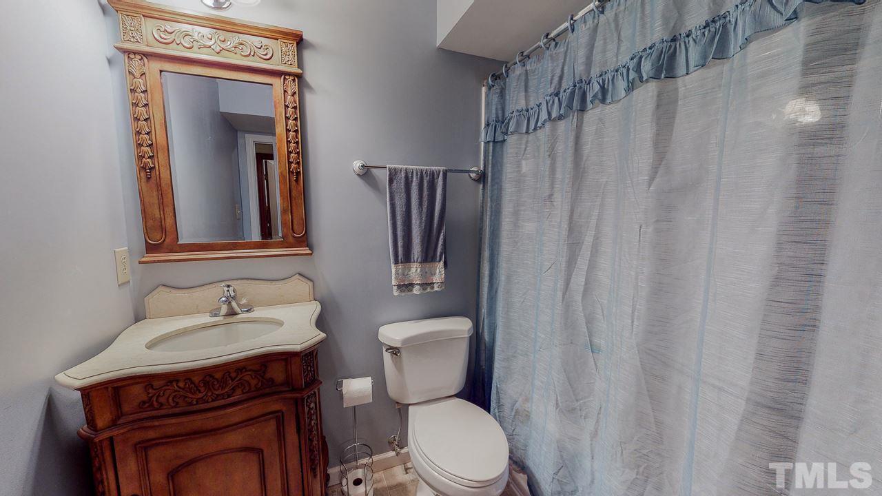 1307 Bill Poole Road Rougemont, NC 27572 - Photo 23 of 30 a bathroom with a toilet a sink and mirror