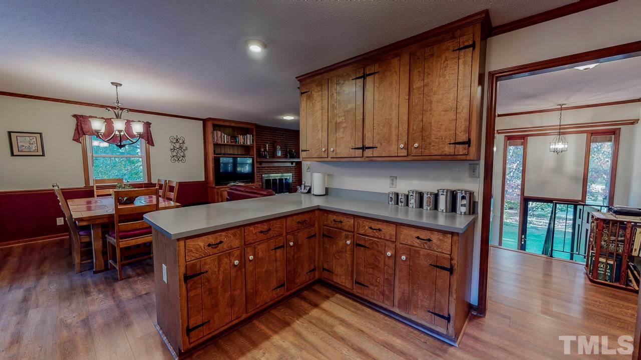 1307 Bill Poole Road Rougemont, NC 27572 - Photo 7 of 30 a kitchen with stainless steel appliances granite countertop a stove a sink dishwasher and cabinets with wooden floor