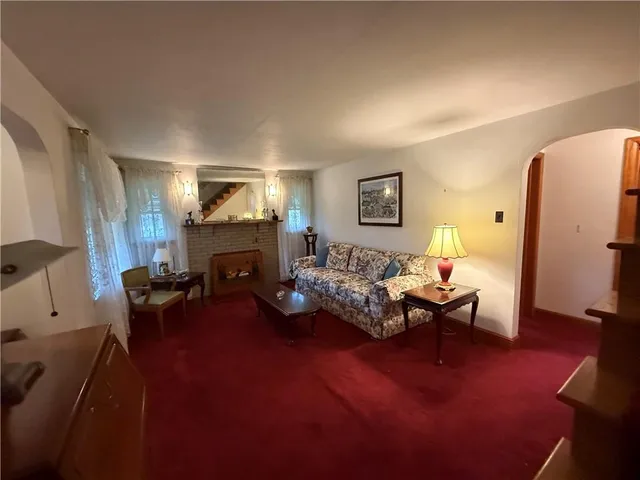 a living room with furniture and a stair