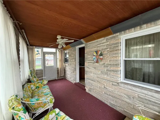 a front view of a house with outdoor seating