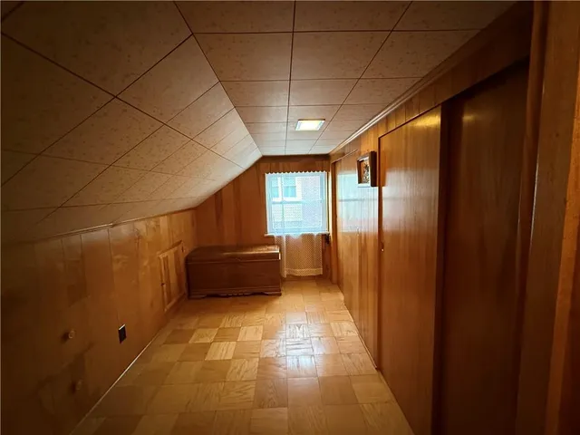 a view of a room with wooden floor and windows