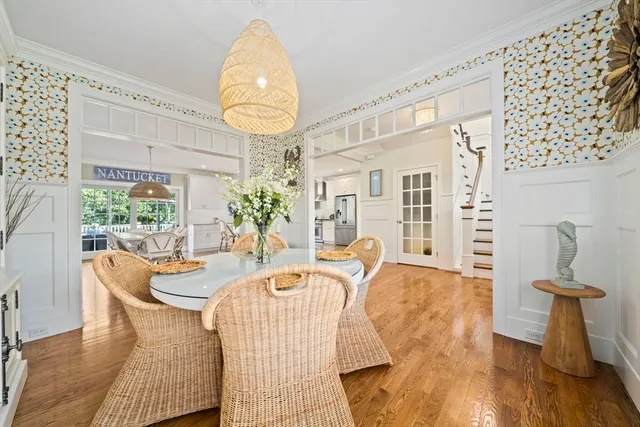 a living room with furniture a chandelier and a large window