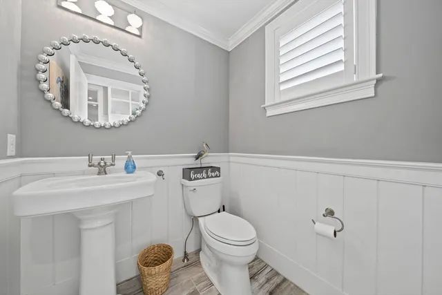 a bathroom with a sink a mirror and a toilet