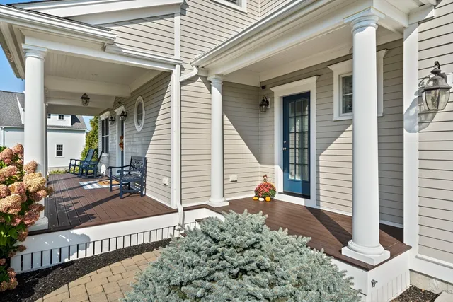 a view of a porch with two chairs and a potted plant