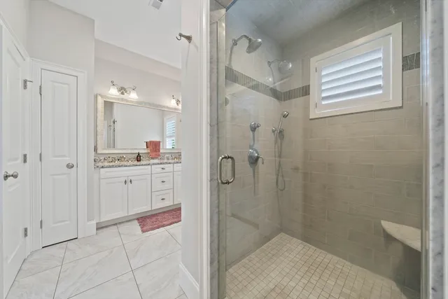 a bathroom with a shower and a sink