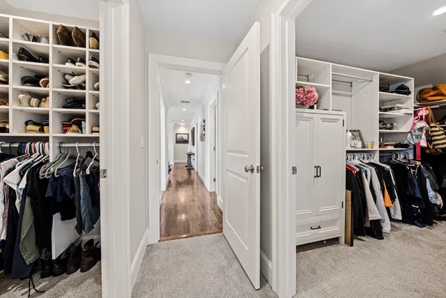 a view of walk in closet with clothes and shoes