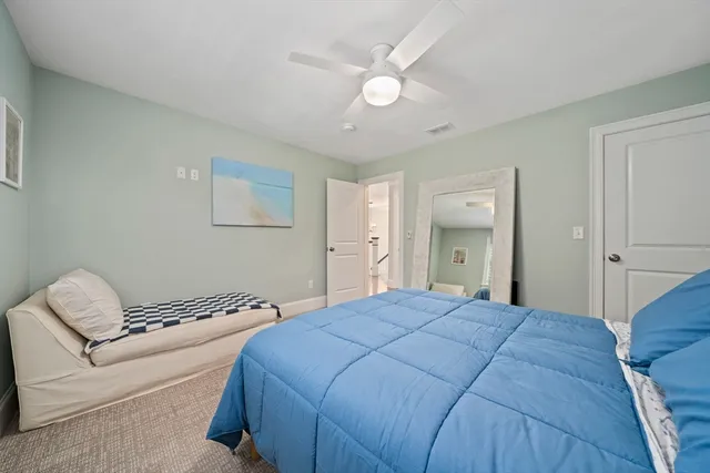 a bedroom with a bed and a couch