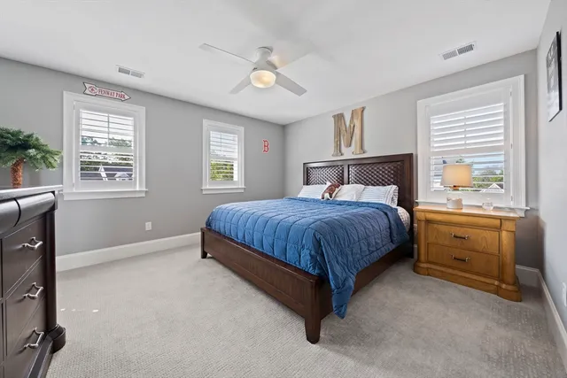 a bedroom with a bed dresser and a window