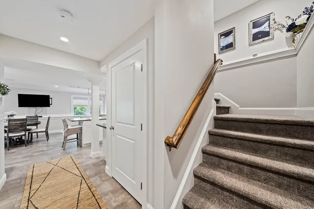 a view of a livingroom with furniture and staircase