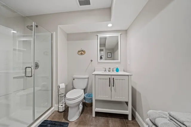 a bathroom with a toilet a sink and shower