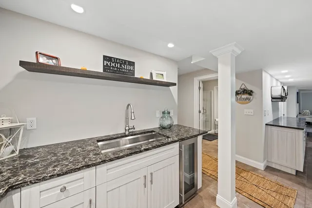 a kitchen with granite countertop a sink and cabinets