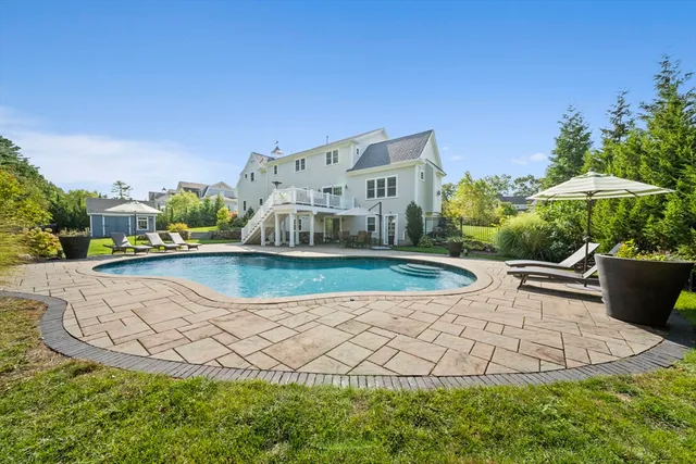 a view of a swimming pool with a yard