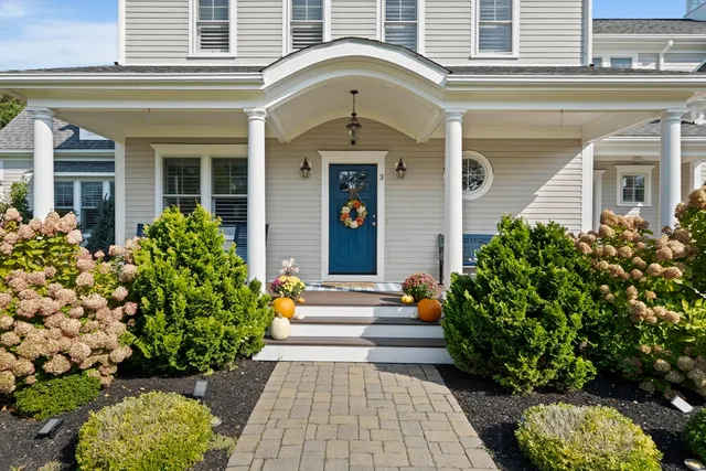 front view of a house with potted plants