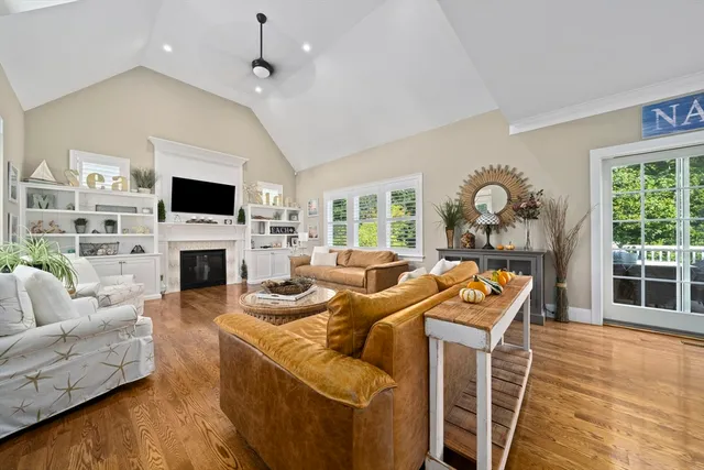 a living room with furniture a fireplace and a flat screen tv