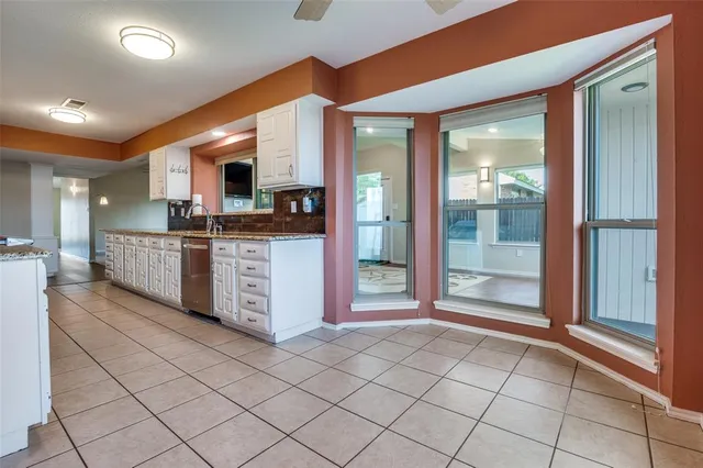 a open kitchen with stainless steel appliances granite countertop a stove and a sink