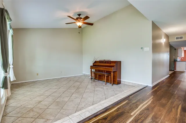 an empty room with a empty space and windows