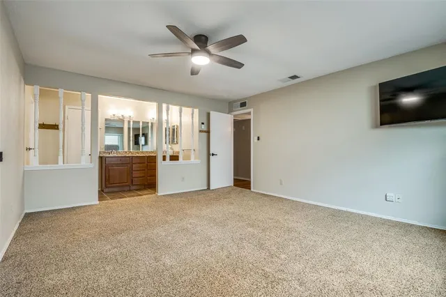 a bathroom with a granite countertop sink a large mirror and a shower
