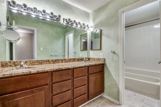 a view of a backyard with plants and large trees