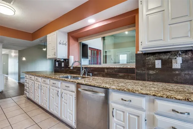 a sink with granite countertop a sink and cabinets