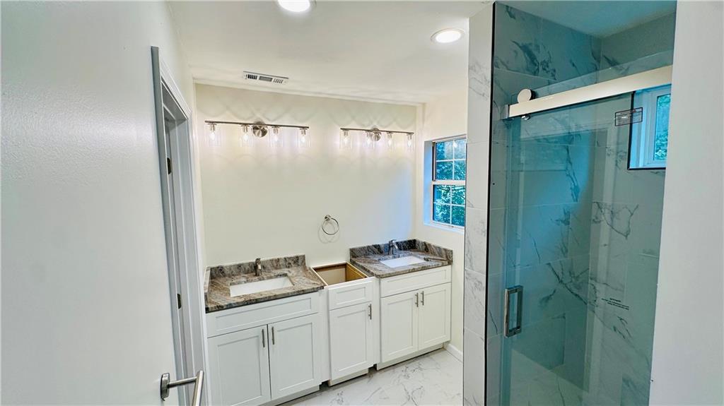 3428 Chapel Park Drive Decatur, GA 30034 - Photo 12 of 35 a bathroom with a double vanity sink and mirror